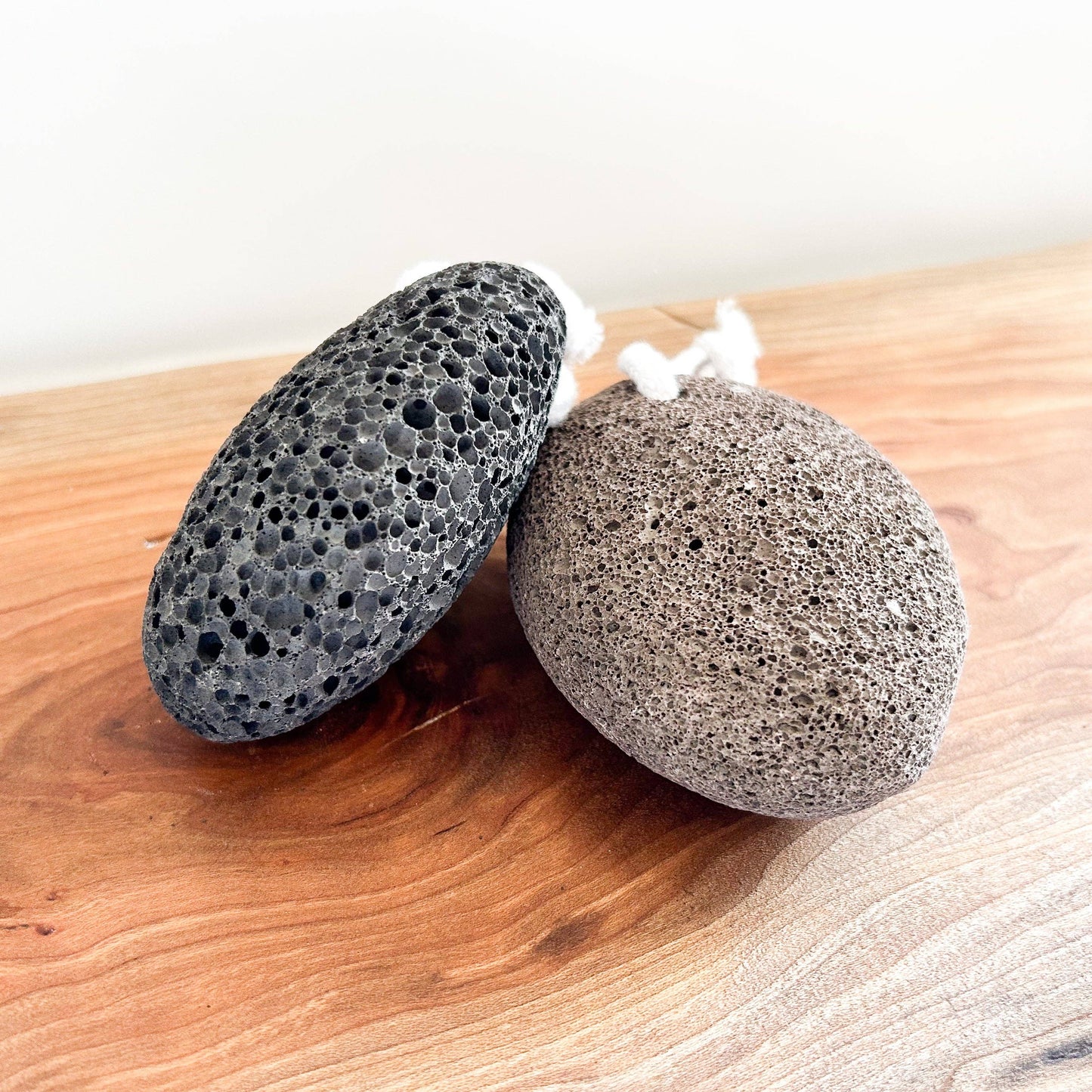Two pumice stones on a wooden surface