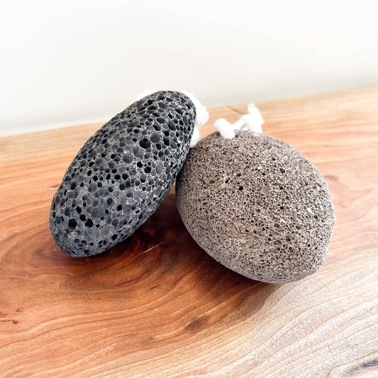 Two pumice stones on a wooden surface