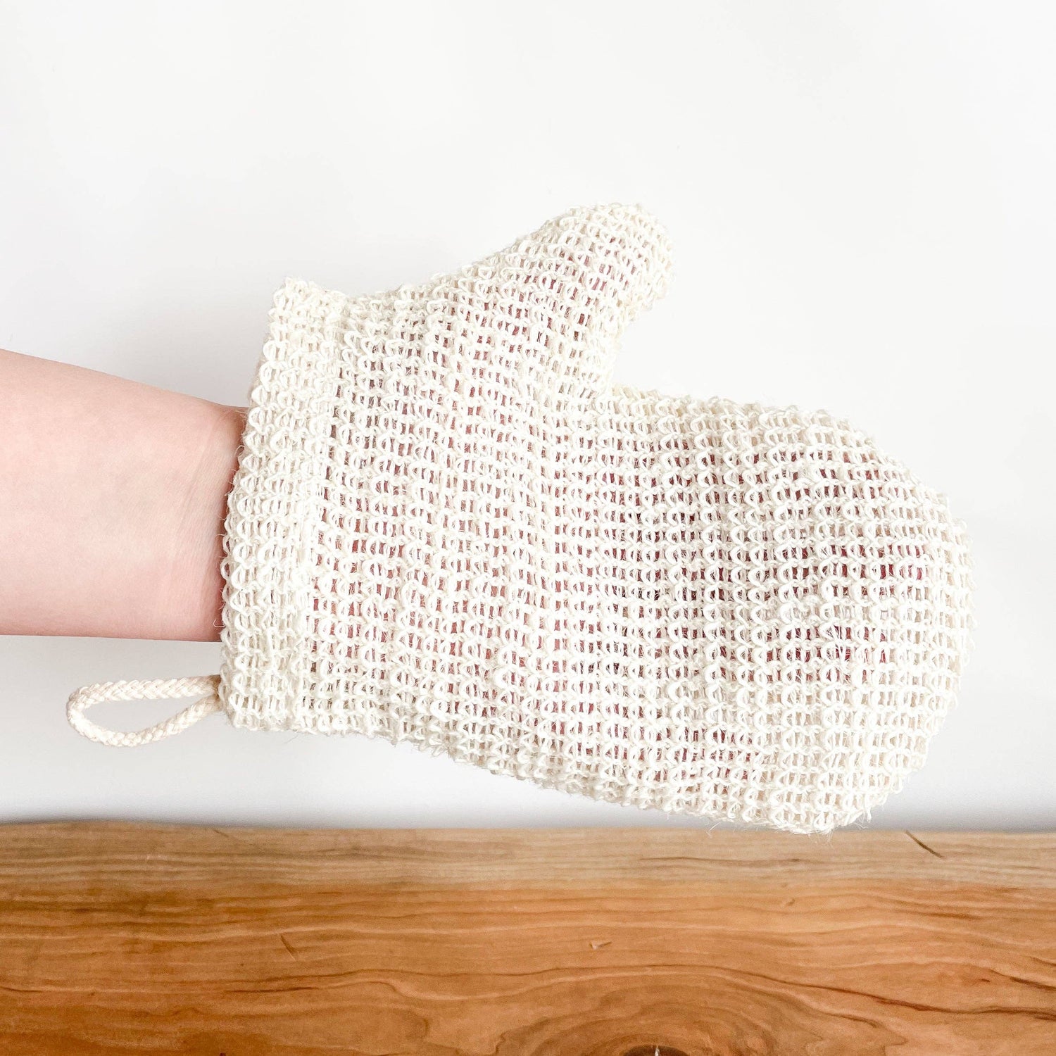 White mesh scrubber with a handle 
