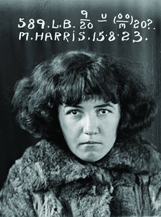 Black and white mugshot of a woman with text overlay on a dark background