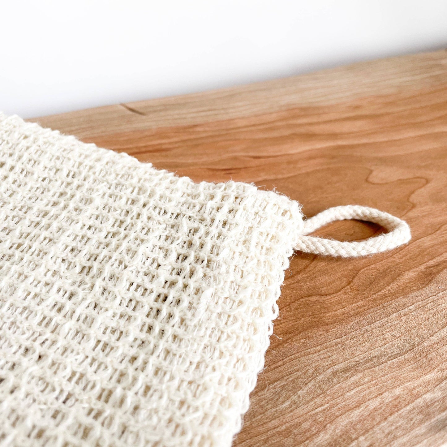 White mesh scrubber with a handle 