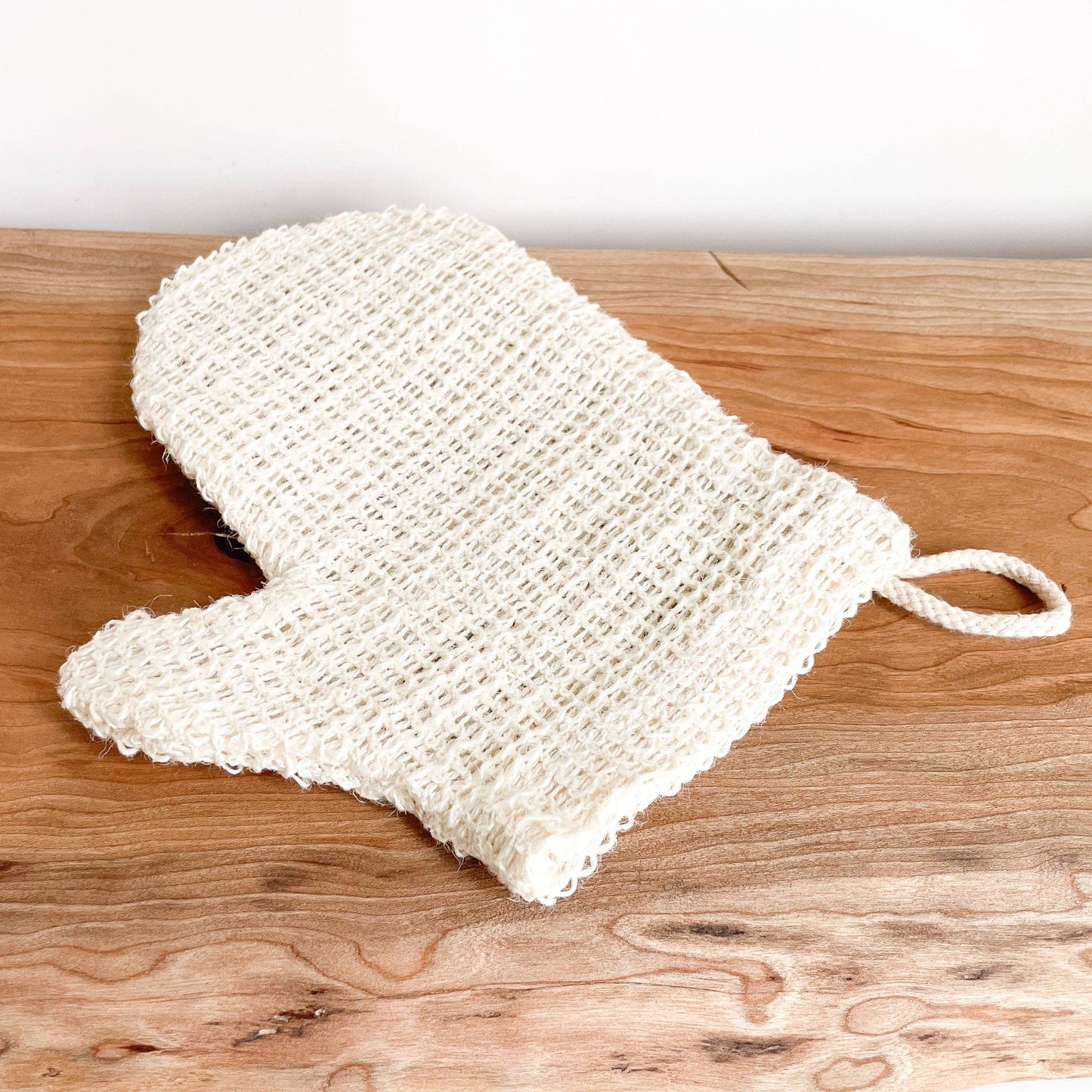 White mesh scrubber with a handle 