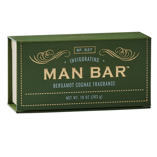 A green bar of soap with gold and white text that reads 'MAN BAR Bergamot Cognac Fragrance' and indicates the net weight of 10 oz (283 g).