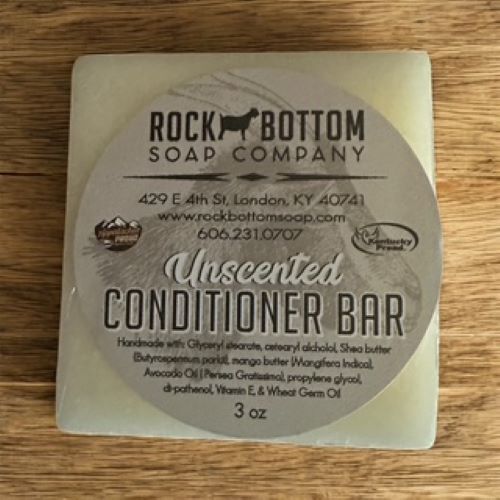 Unscented conditioner bar from Rock Bottom Soap Company on a wooden surface