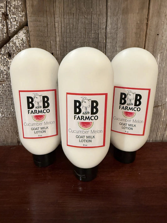 B&B Farmco cucumber melon goat milk lotion on a wooden surface with a wooden background.
