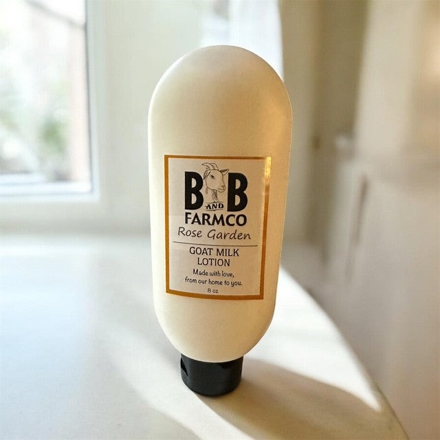 B&B Farmco goat milk lotion bottle on a windowsill with natural light.